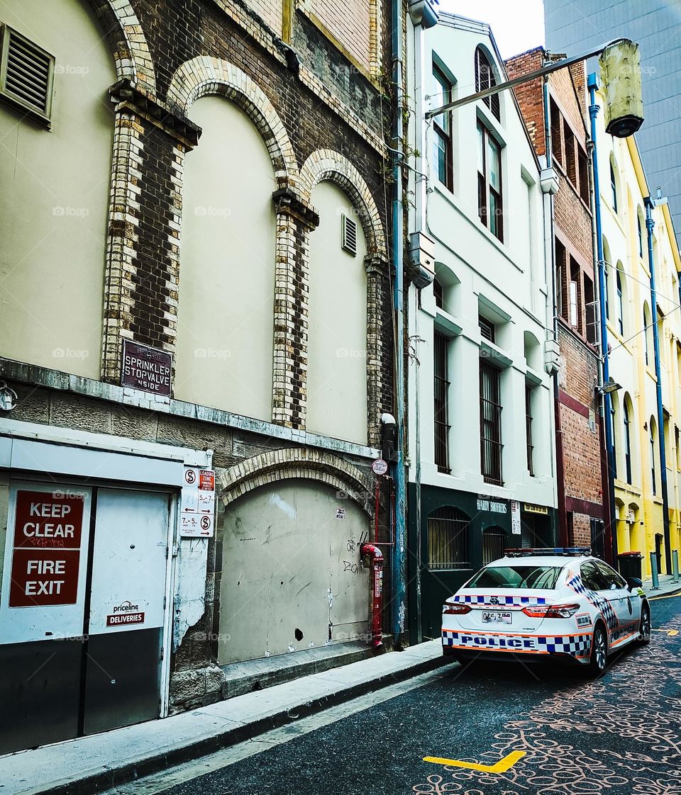 Australian police car parked in a laneway