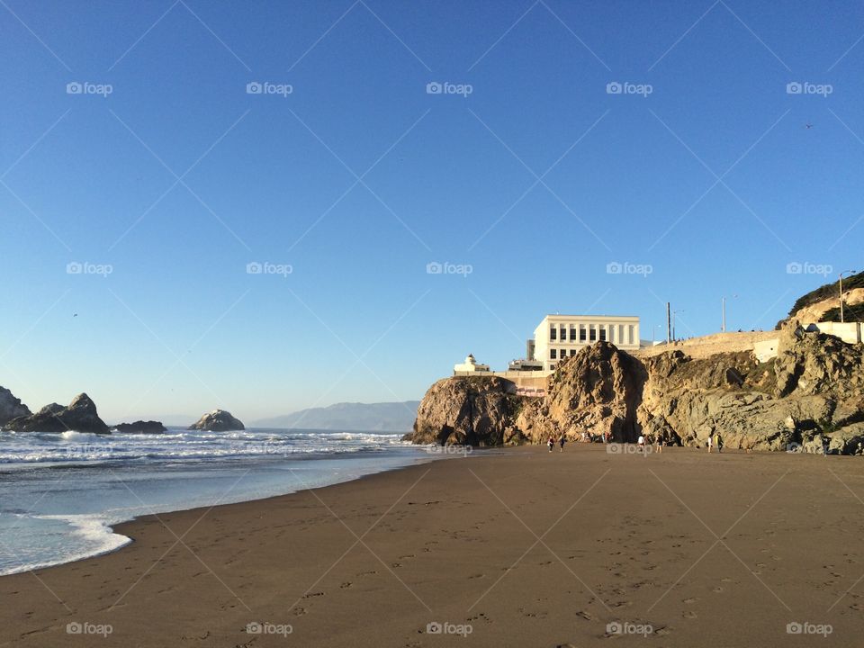 Beach and cliff with a structure on the cliff 