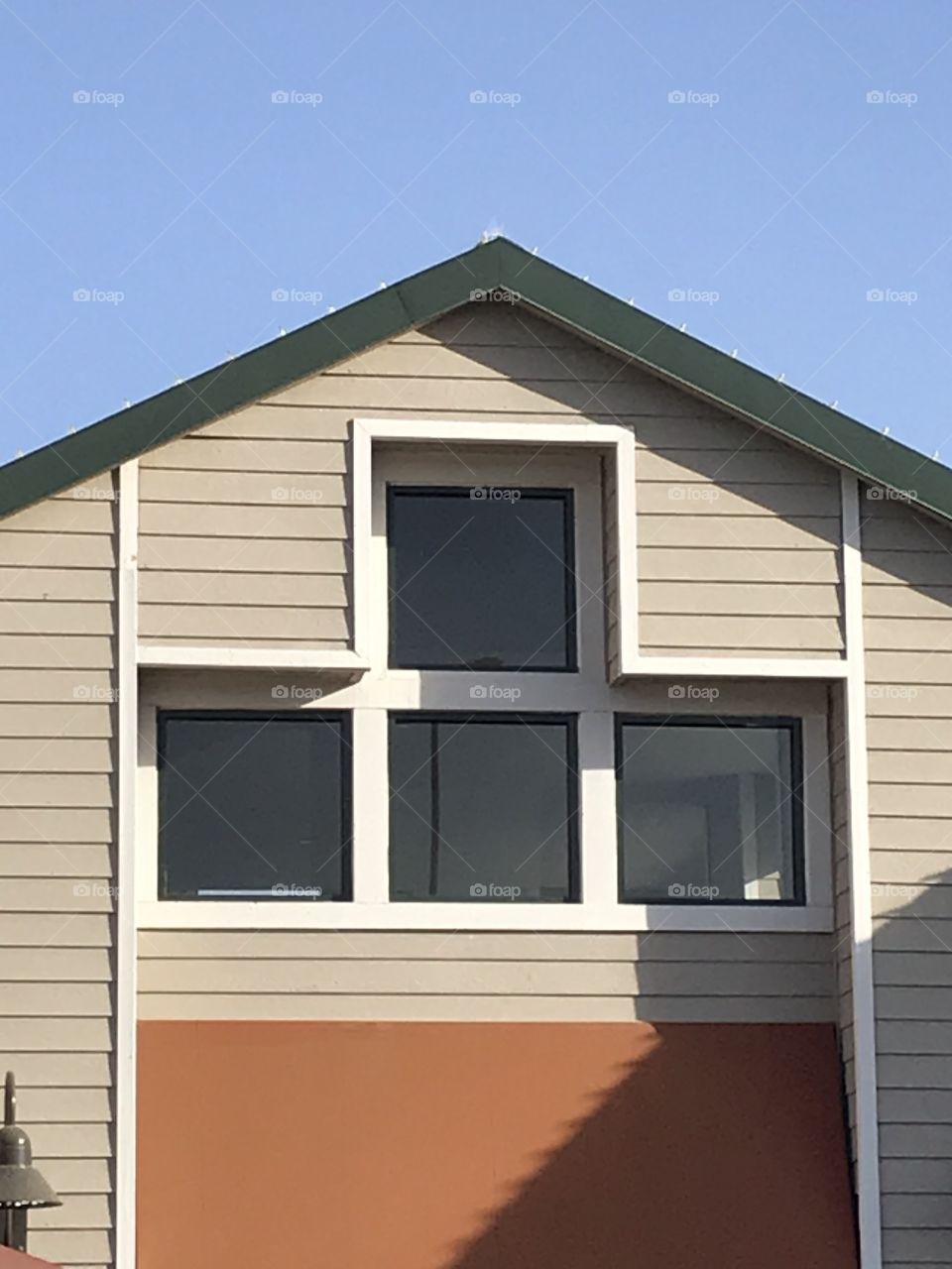 Second story of a building. This portion of the building has an intriguing architectural aspect. It is located in a nice, clean shopping center.