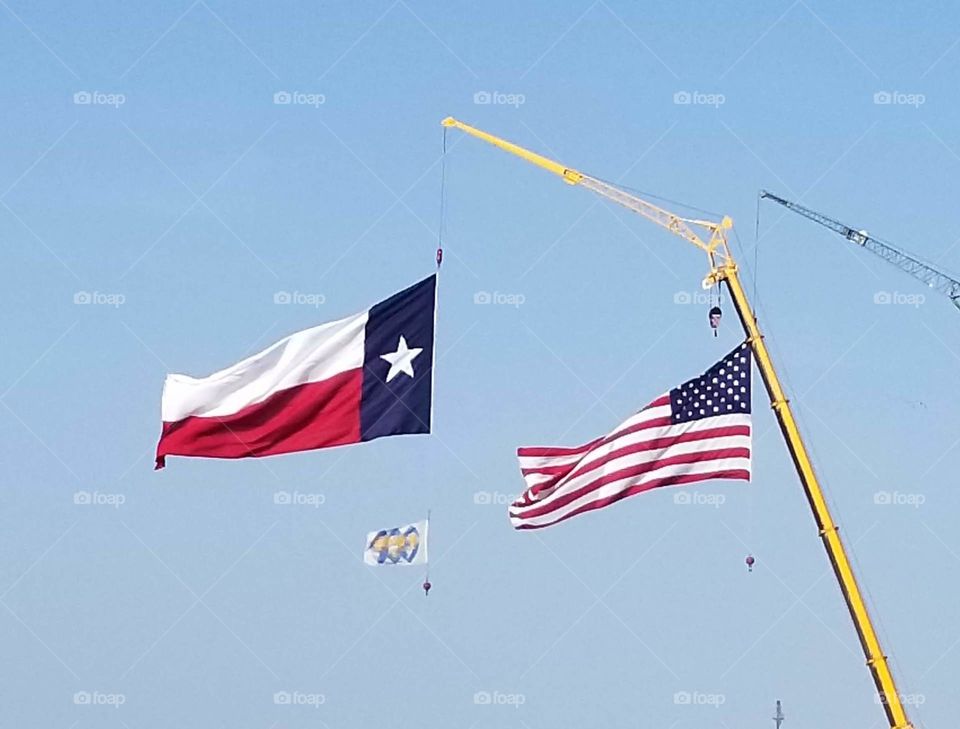 The patriotic displaying the the Texas and United States flags. God Bless America and the Lone Star State. Long may they wave.