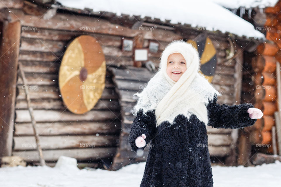 Cute kid in russian village at winter