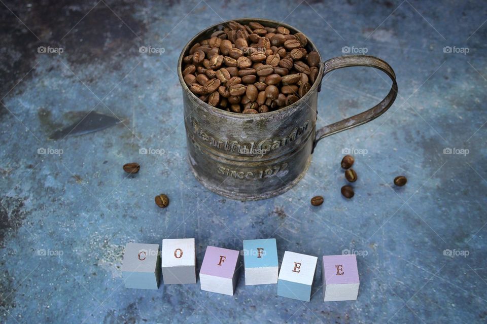 coffee beans in a metal mug