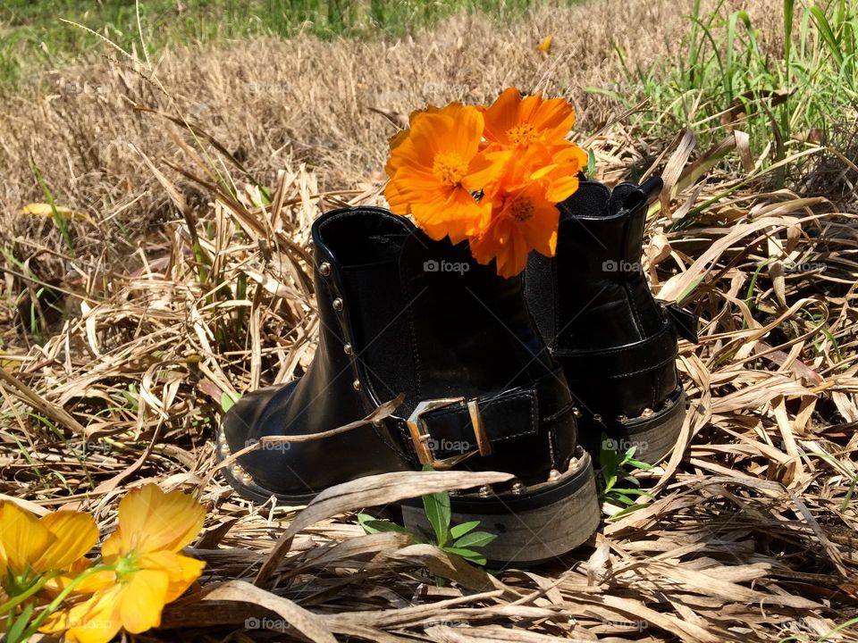 Black boots with orange flower