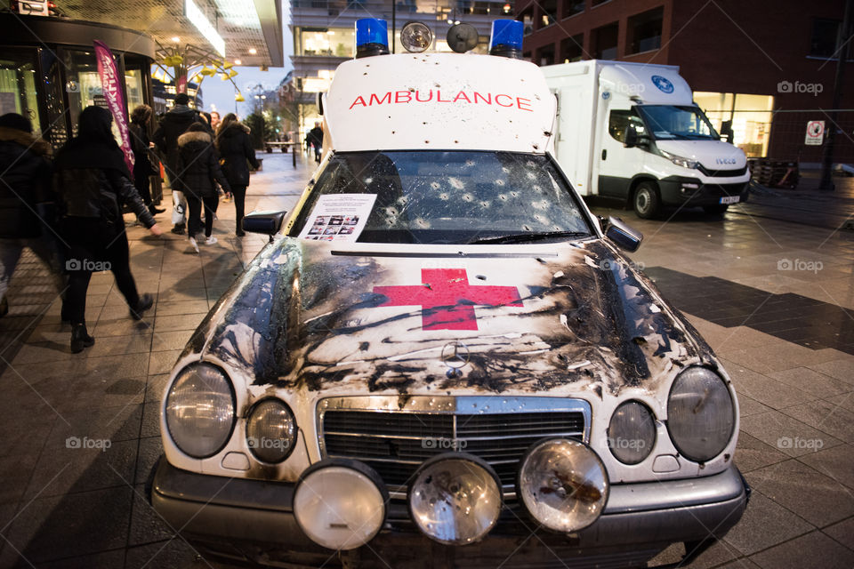 A real ambulance from the Red Cross who had been attacked in war. The Ambulance has bulletholes just everywhere and even firebombs have been thrown against it. The ambulance is part of efforts to make people aware of what happens in war. Ambulance shown up in various parts of the world. The picture is from Malmö Sweden.