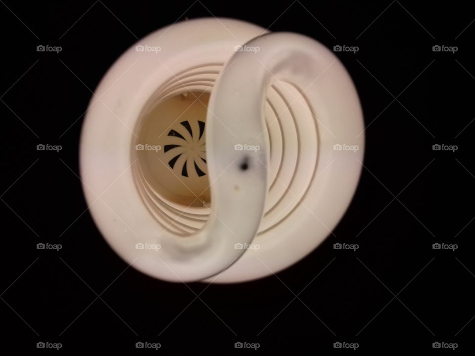 Spiral energy saving light lamp bulb on dark background