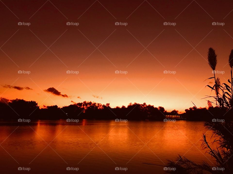 Another Beautiful Sunset to Twilight to Night photo. Peaceful Lake Waters hearing Fish Feed Top Water to a sharp ending then Night.