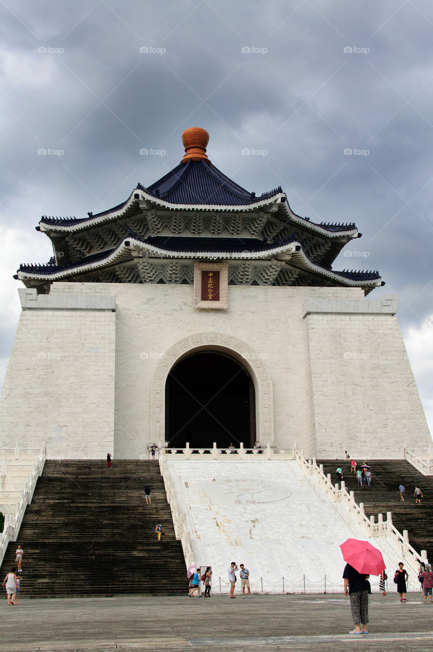 A woman stands in front of Chaing Kai Shek Memorial Hall in Taipei 