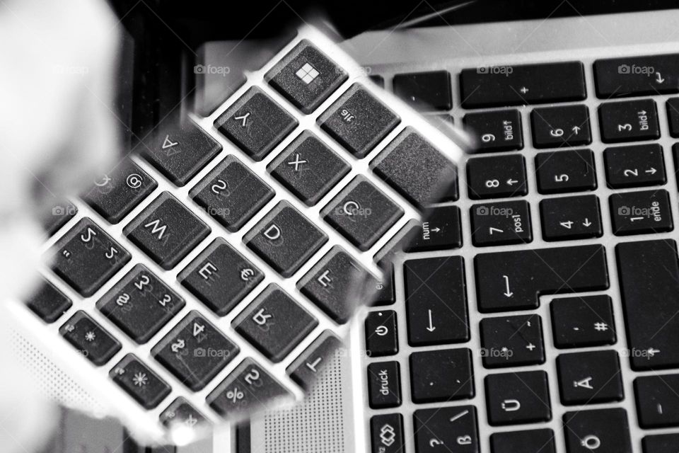 Reflection of a PC keyboard in a broken mirror