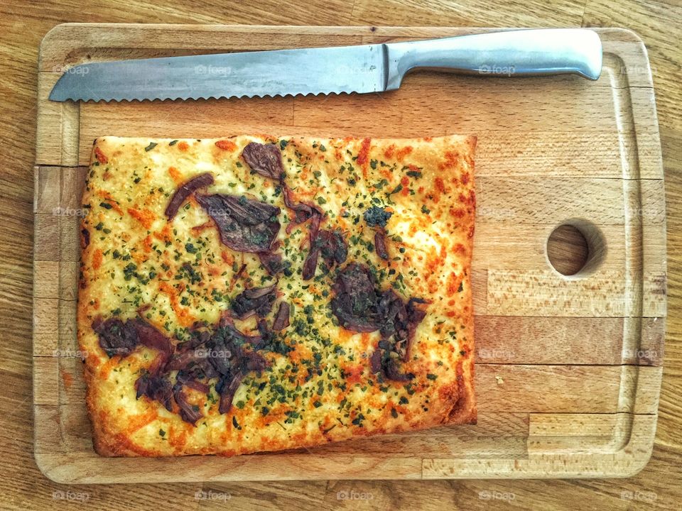 Bread with knife on cutting board