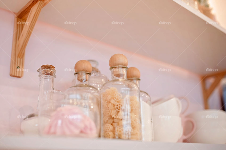 Festive winter cozy kitchen interior with garlands, decorations and gifts.  Christmas dinner at the decorated table.