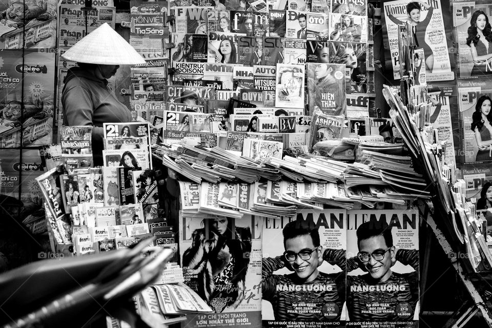 A lady selling magazines on the street of Ho Chi Minh city