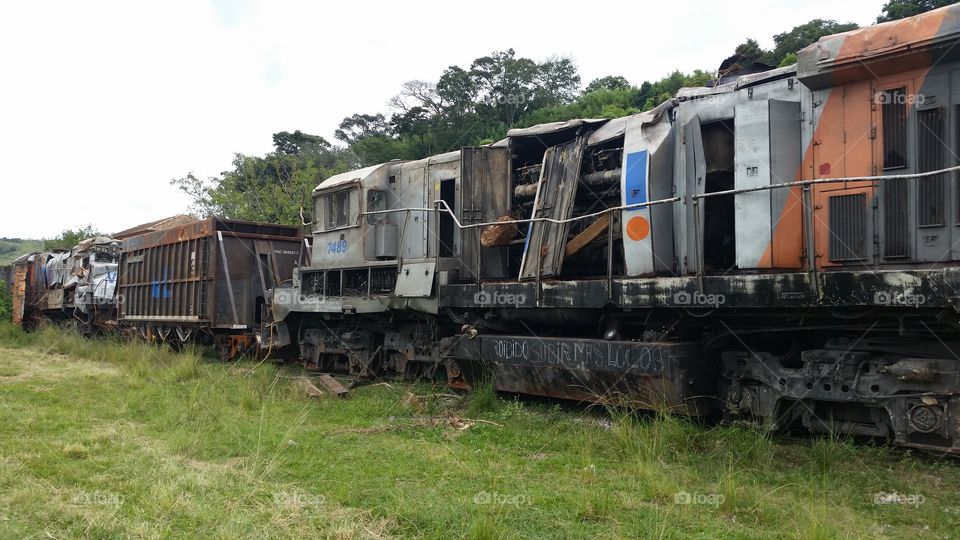 Rusty abandoned train in grassy field