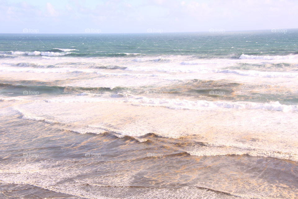 white cap waves lapping the shore