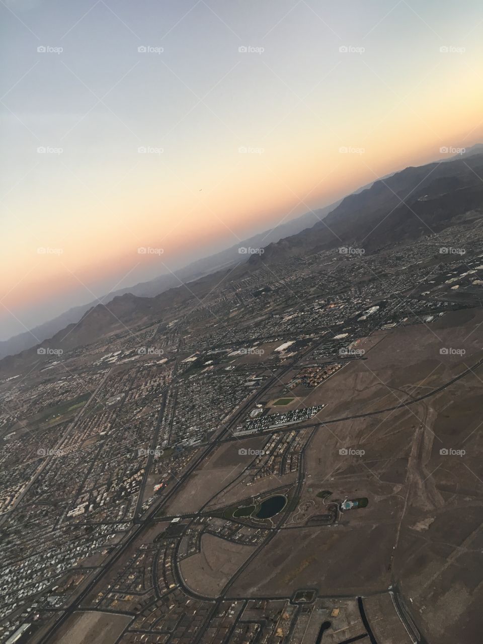 A scenic view from the airplane window. Gorgeous colors from the sunset while traveling.