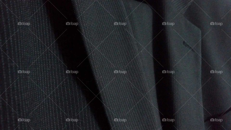 detail of a black striped suit