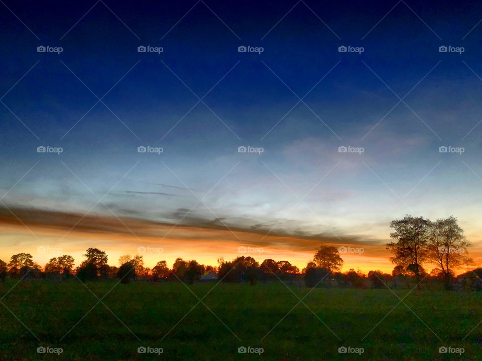 Dramatic and colorful Dusk sky over a Countryside landscape 
