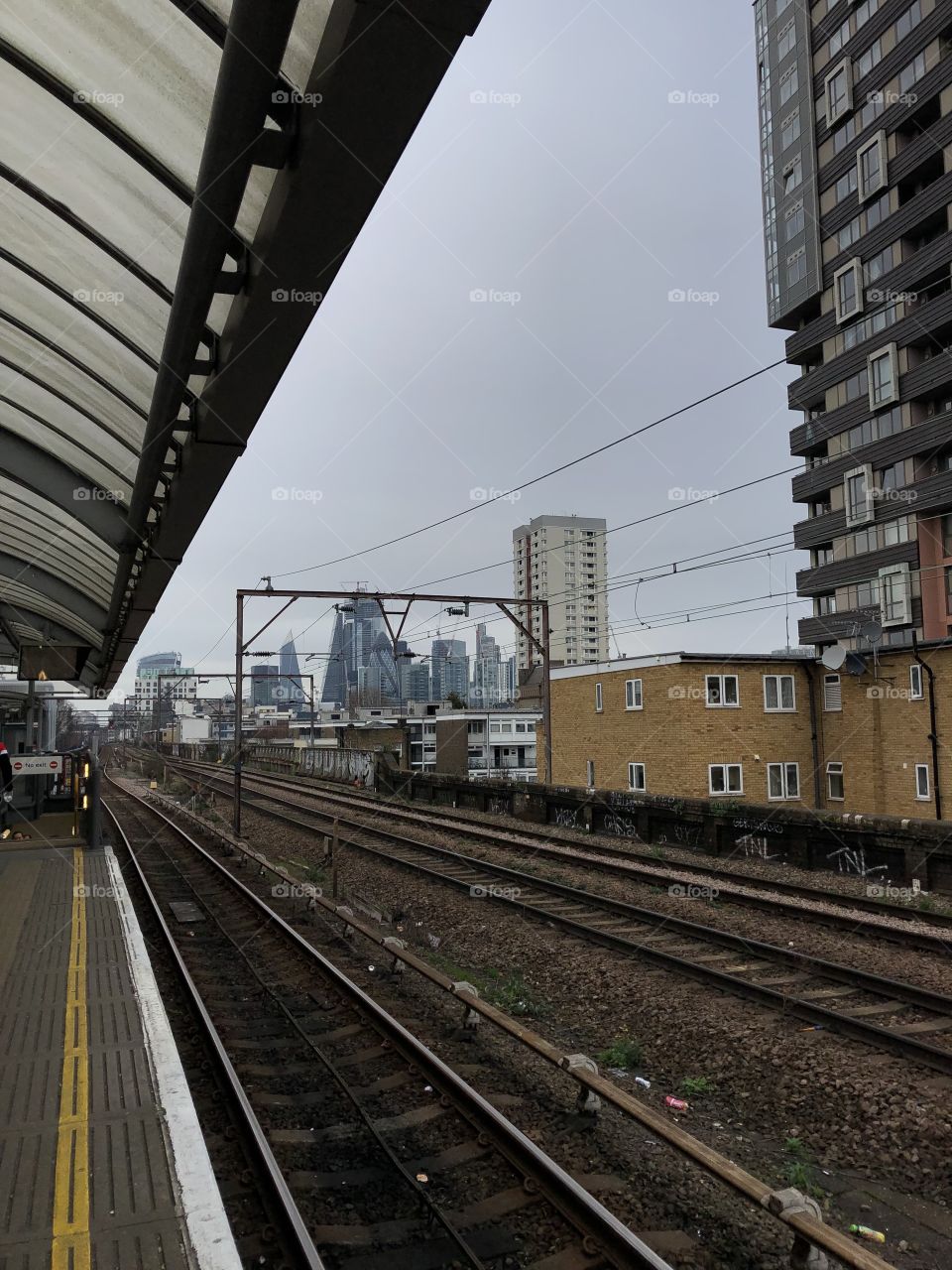 A dark and cloudy morning at Shadwell DLR station looking at the Bank/Monument (City) area of London.