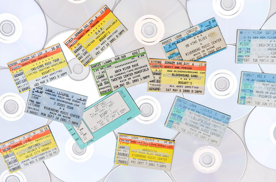 Flat lay overhead shot of a collage of CDs and concert ticket stubs