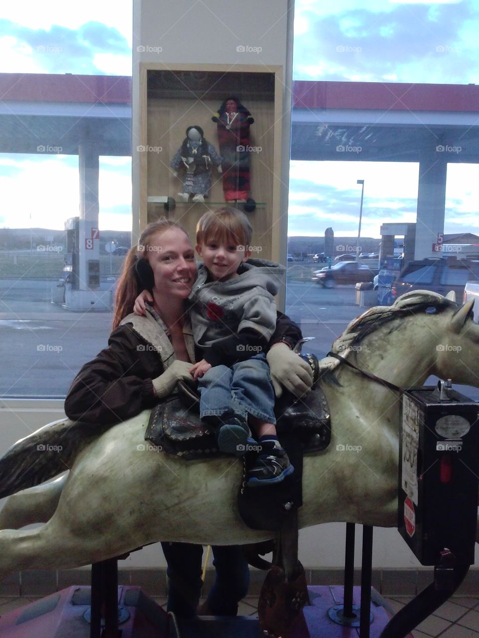 My babies. This is my daughter and my grandson in an Indian store in Montana.  He had to ride this horse.