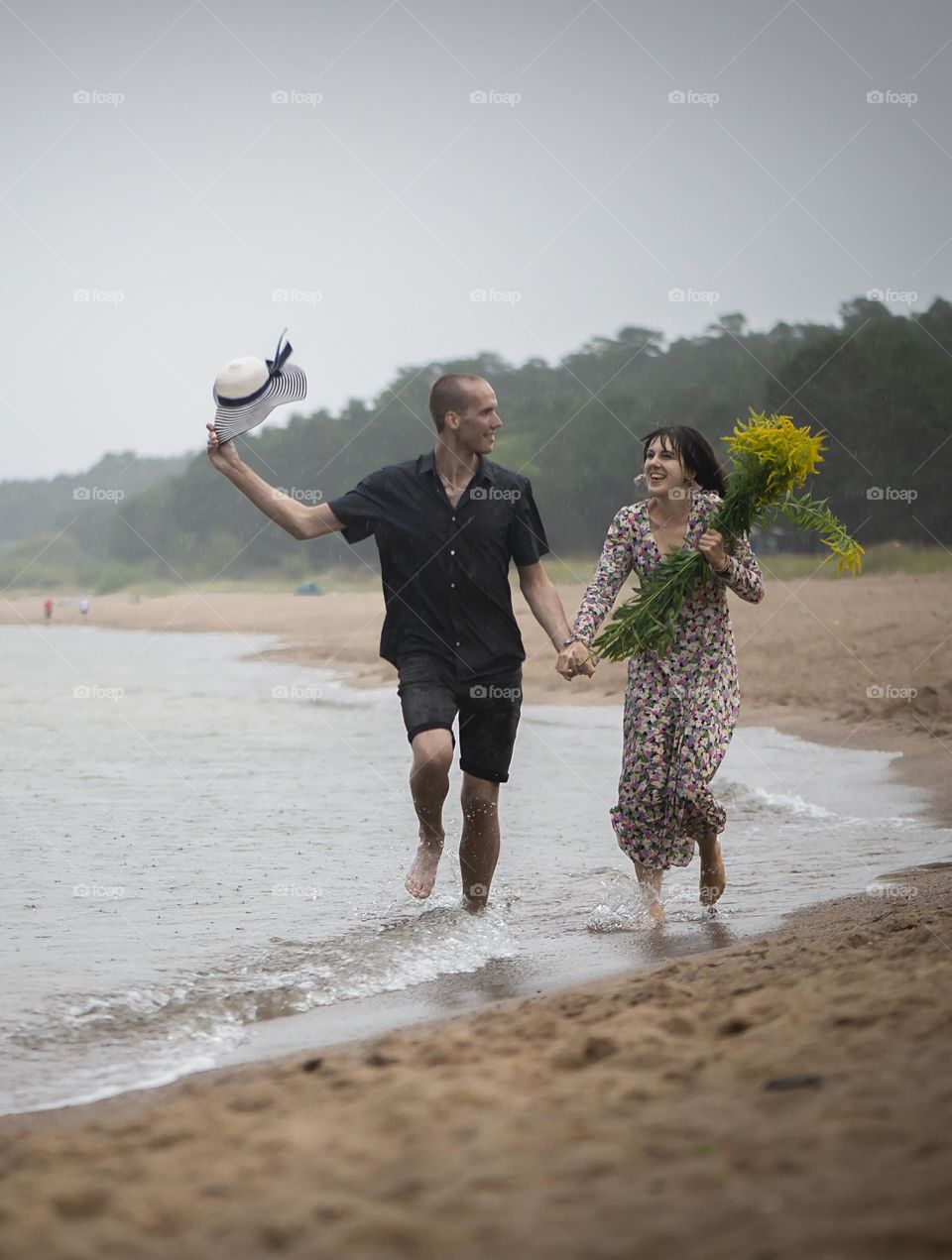 Happy couple running at beach
