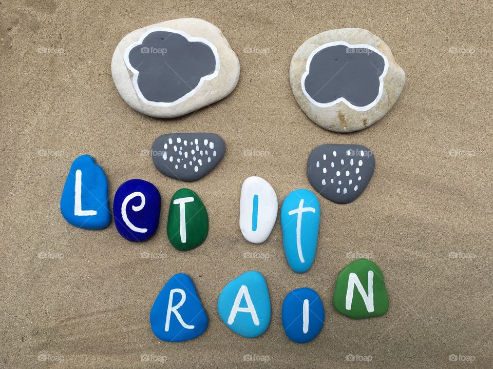 Let it rain, conceptual stones composition over the sand