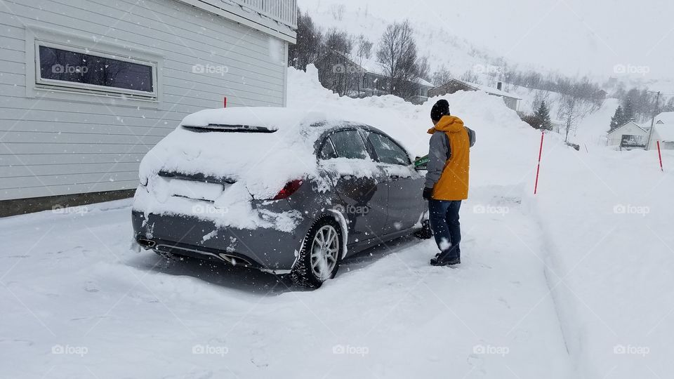 Scrapping snow off the car