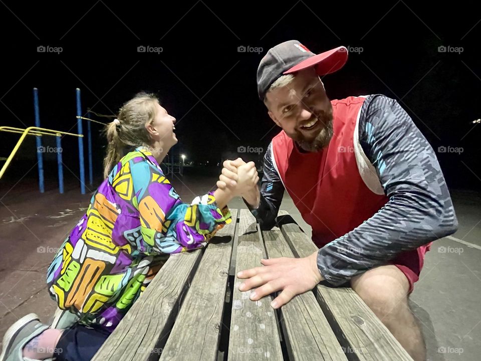 Arm wrestling between dad and daughter
 