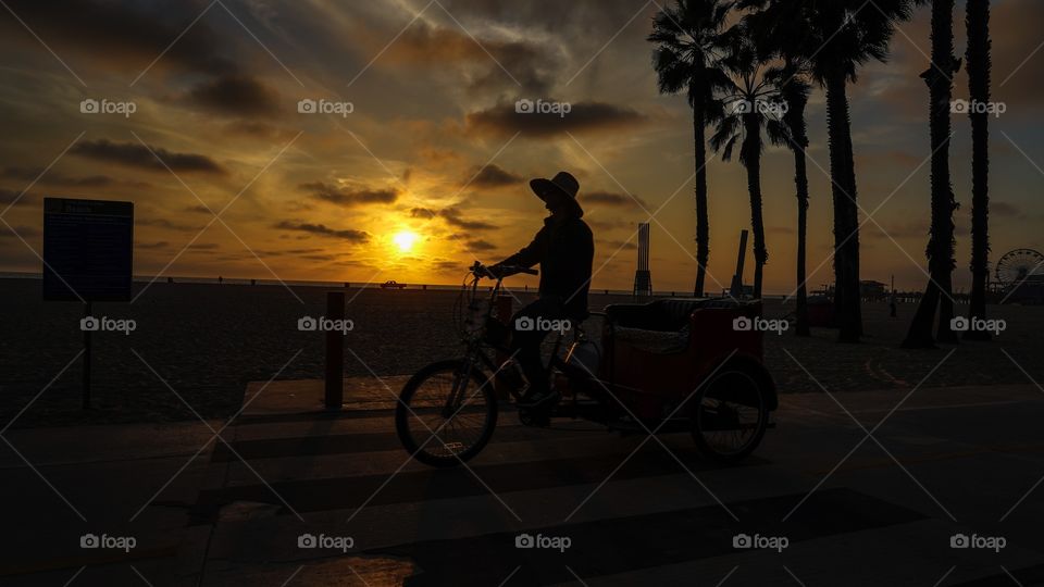Biking at beach during sunset 