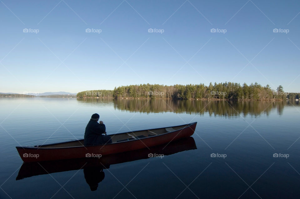 Man paddling his canoe I like Winnipesaukee New Hampshire