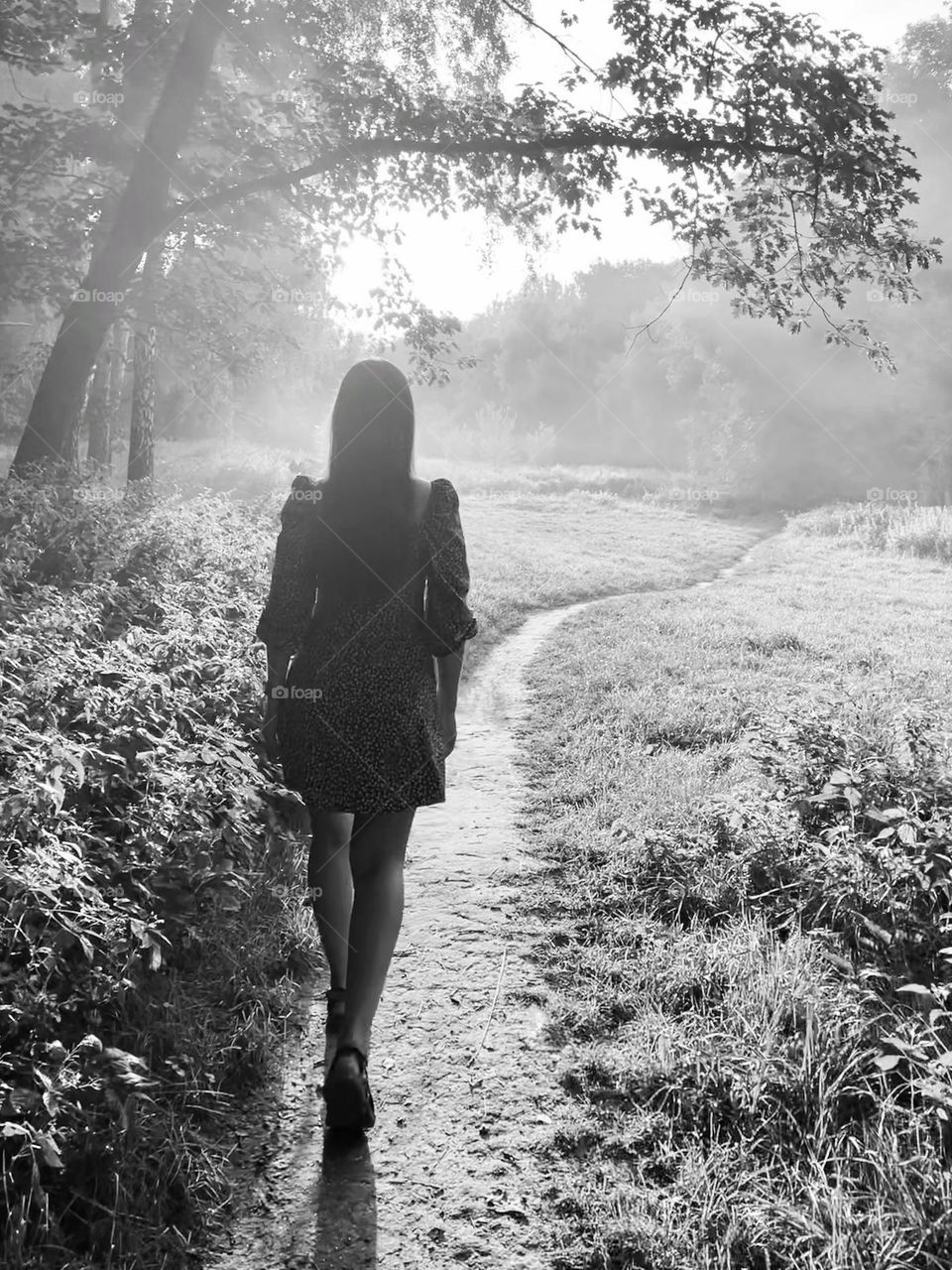 The girl is walking. Black and white photo.