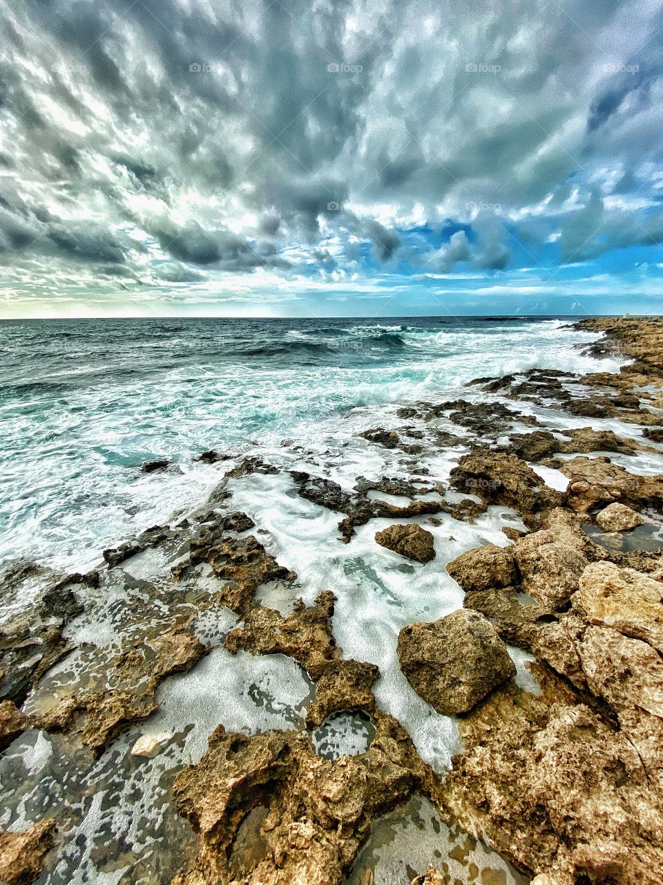 Amazing sight on a stormy day by the sea in Paphos, Cyprus. I never get tired of this view! The sound of the waves covering the rocks in the seafront is something so relaxing!