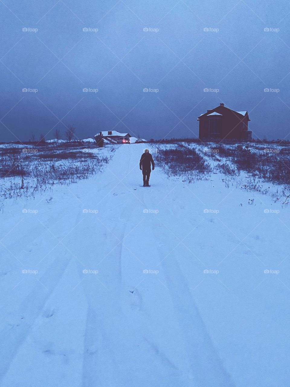 lonely man walking in the snow