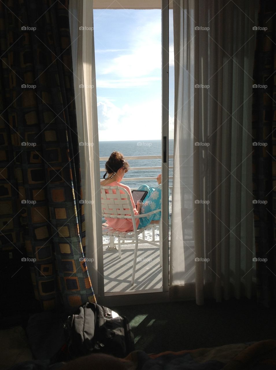 Girl reading with ocean view