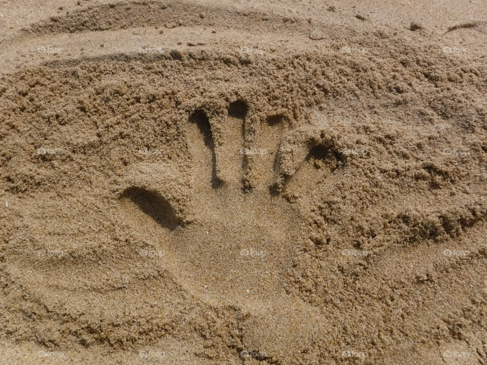 Hand print in the sand