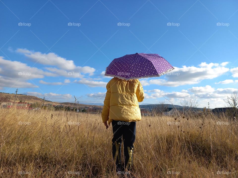 autumn landscape and a girl with an umbrella.