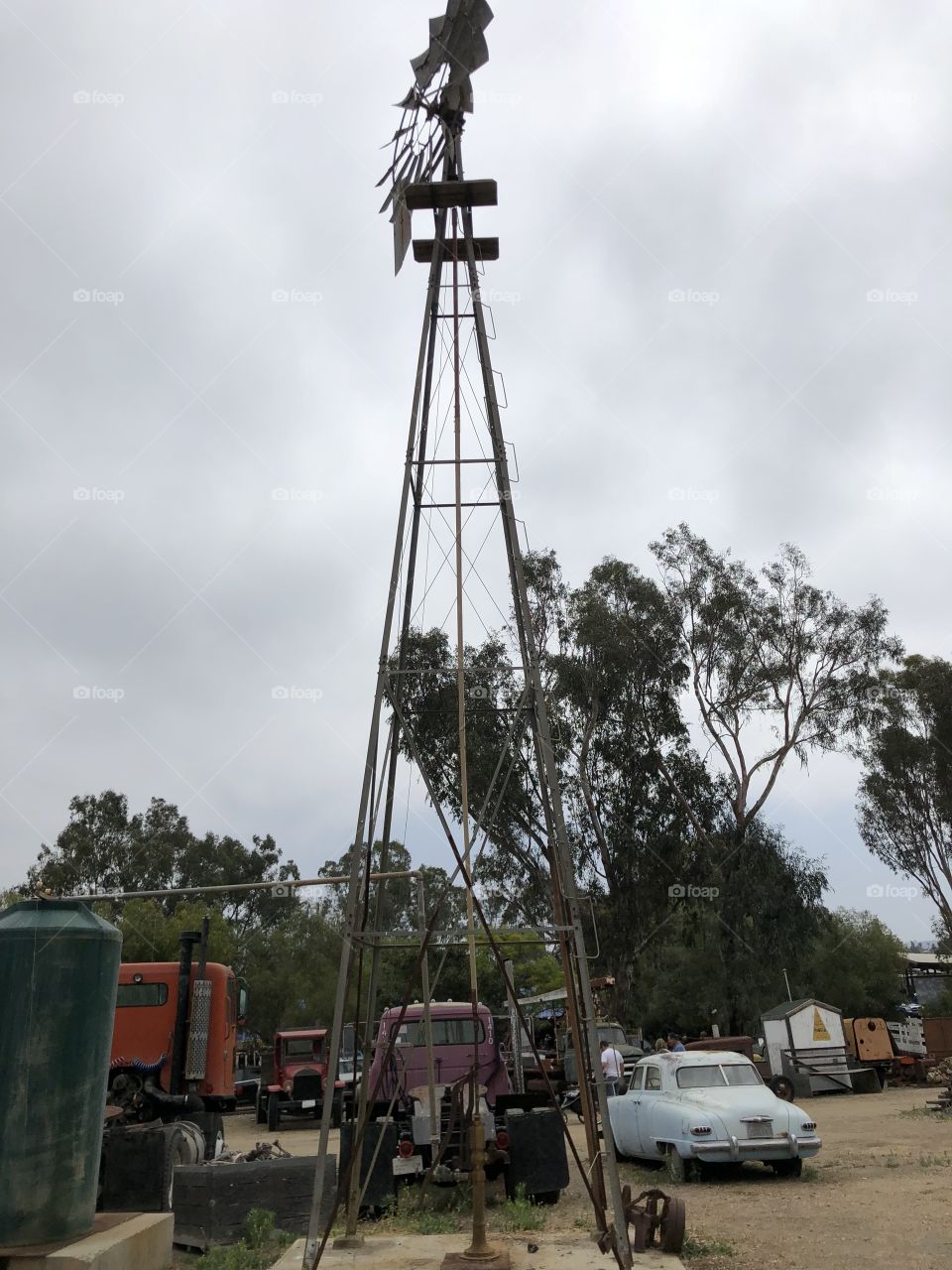 Old windmill and junk cars and trunks