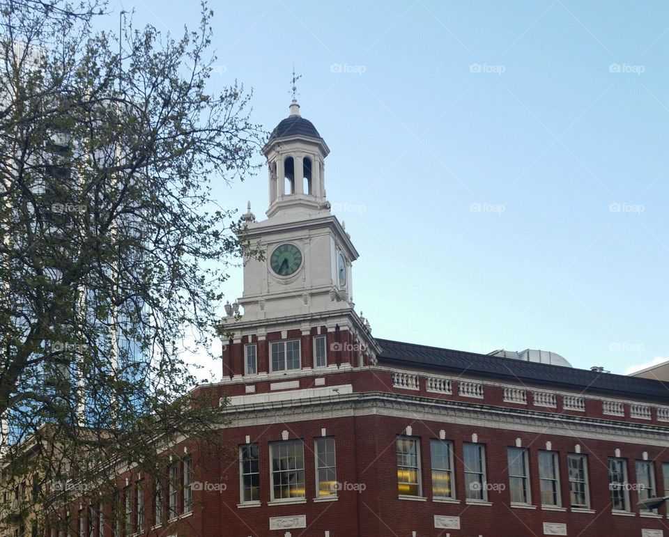 Historic brick Telegram building with clock tower and a tree in city of Portland Oregon