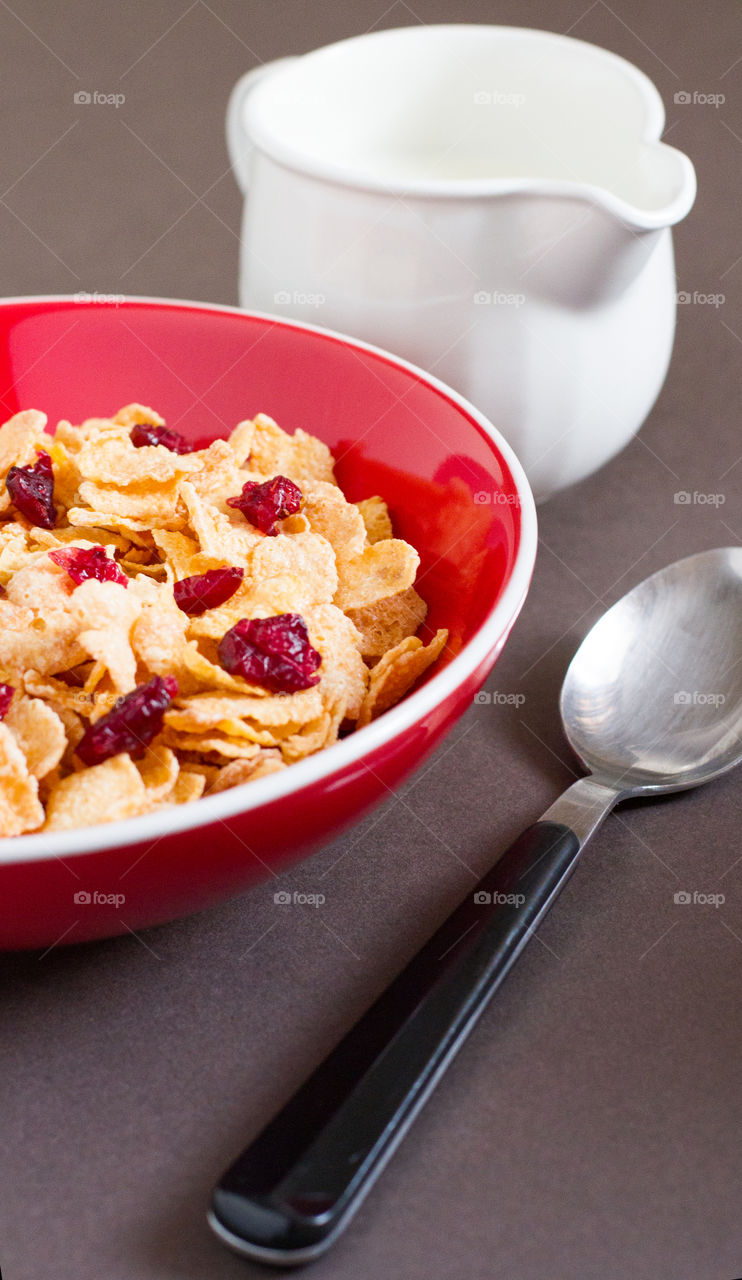 A bowl full of Kellogg's Frosties with extra cranberries to add taste and texture to the breakfast.