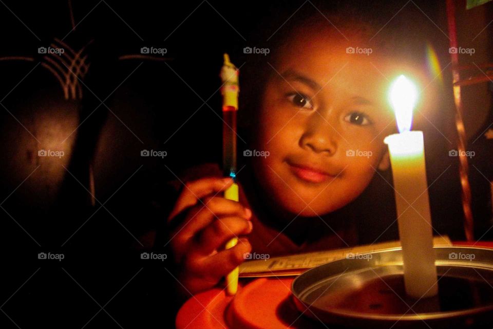 Child Smiling Face appears from the dark room.