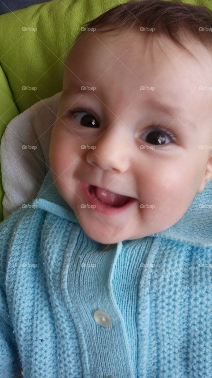 Close-up of baby boy with knitted sweater
