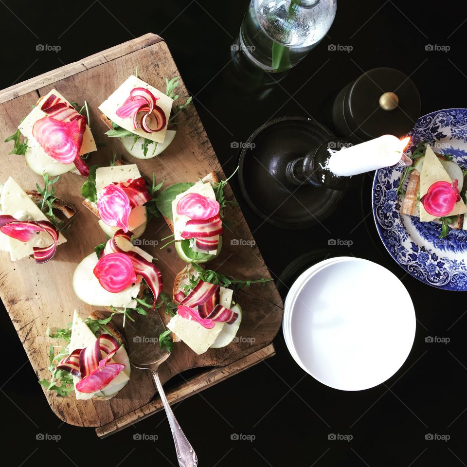 Beets and cheese sandwishes on a rustic cuttingboard 