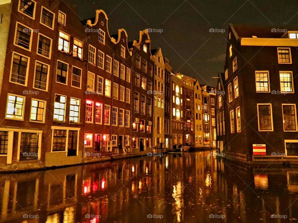 View on historic houses along a canal at night in the Netherlands