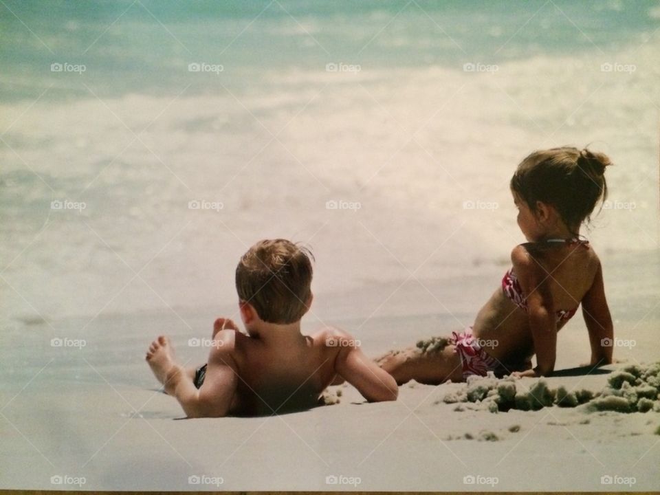 Boy and girl chilling on the beach