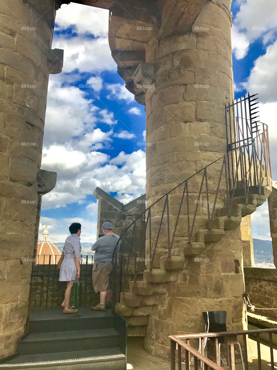 At the top of Palazzo Vecchio, 2 tourists stop to see the view!