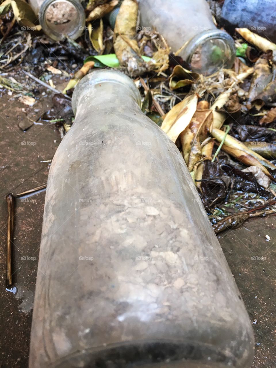 An antique grey bottle on its side 