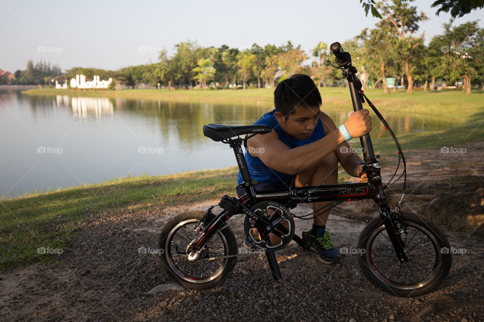 Man fixing bike in the park