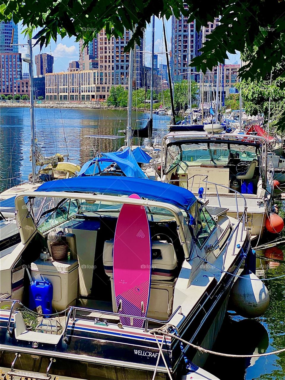 This is a beautiful tree lined closeup on „Newtown Creek“ by the „Pulaski Bridge“ in LIC, Queens. Across the way in „Greenpoint“, Brooklyn scaffolded construction sites emerge to be finished at some point in time later. 2023. Hypnotic Productions