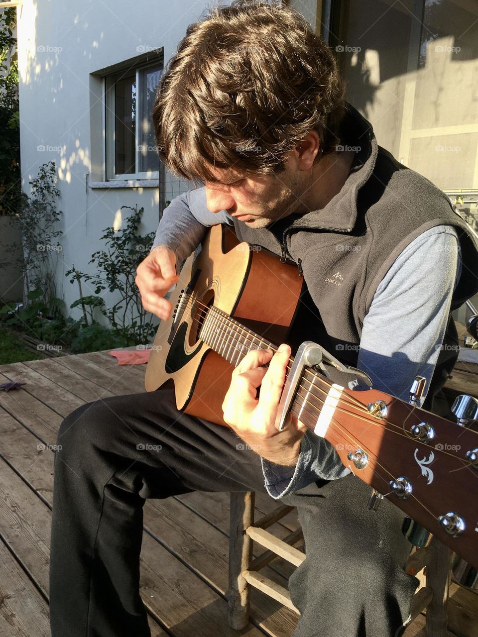 Man playing guitar in sunset light