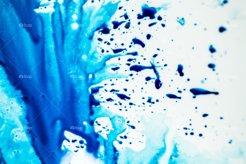 The ink to refill the printer cartridge was spilled onto the white washbasin and the paints blended into abstract drips and patterns.