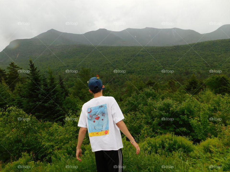 cute boy looking out at some of the white mountains in Lincoln, New Hampshire